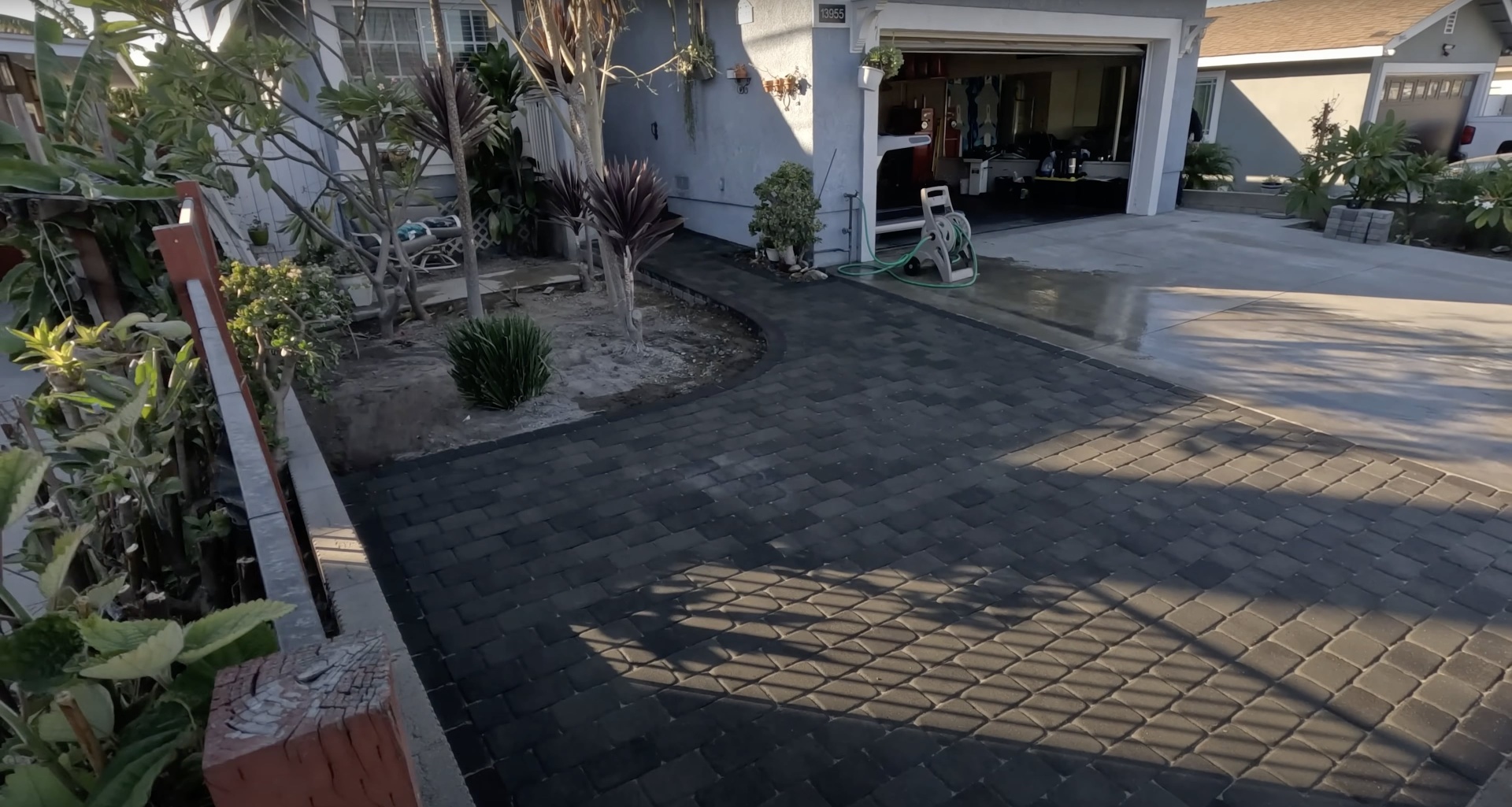 Finished concrete driveway installation by RegalCrest Kent Concrete Beautiful completed concrete driveway and landscaping project in residential setting