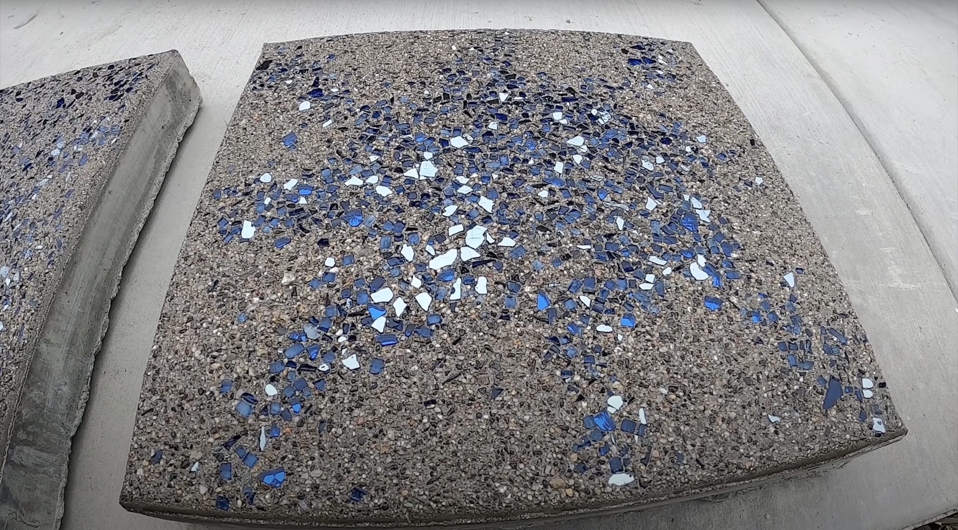 Custom exposed aggregate concrete with decorative glass by RegalCrest Kent Concrete Exposed aggregate concrete sample showing decorative concrete finish with blue glass accents